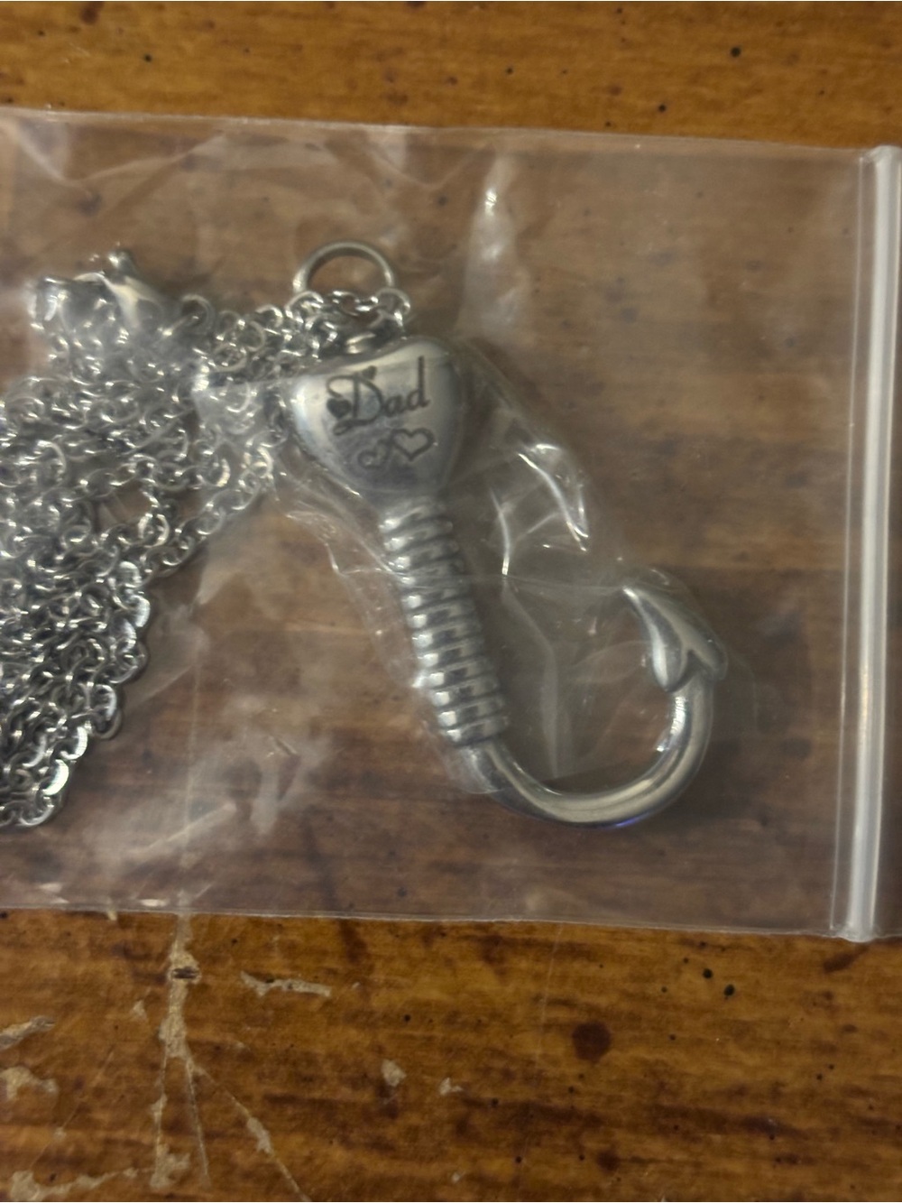 Silver tone memorial necklace. Hollow fishing hook pendant to keep dad close.